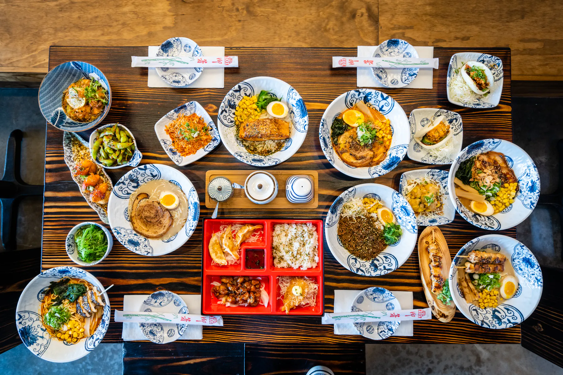 Assorted Japanese izakaya dishes on a table at Aji Izakaya Cypress, a Japanese Restaurant in Cypress
