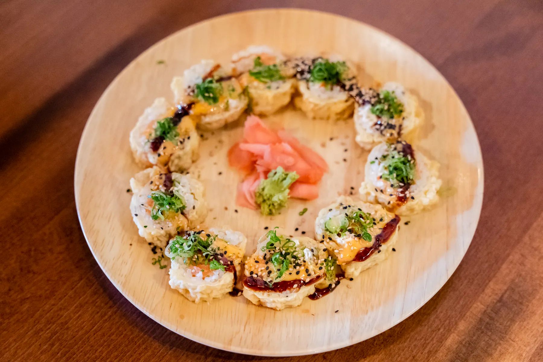 Fried sushi rolls with sauces and garnish at Aji Izakaya Cypress, a Japanese Restaurant in Cypress