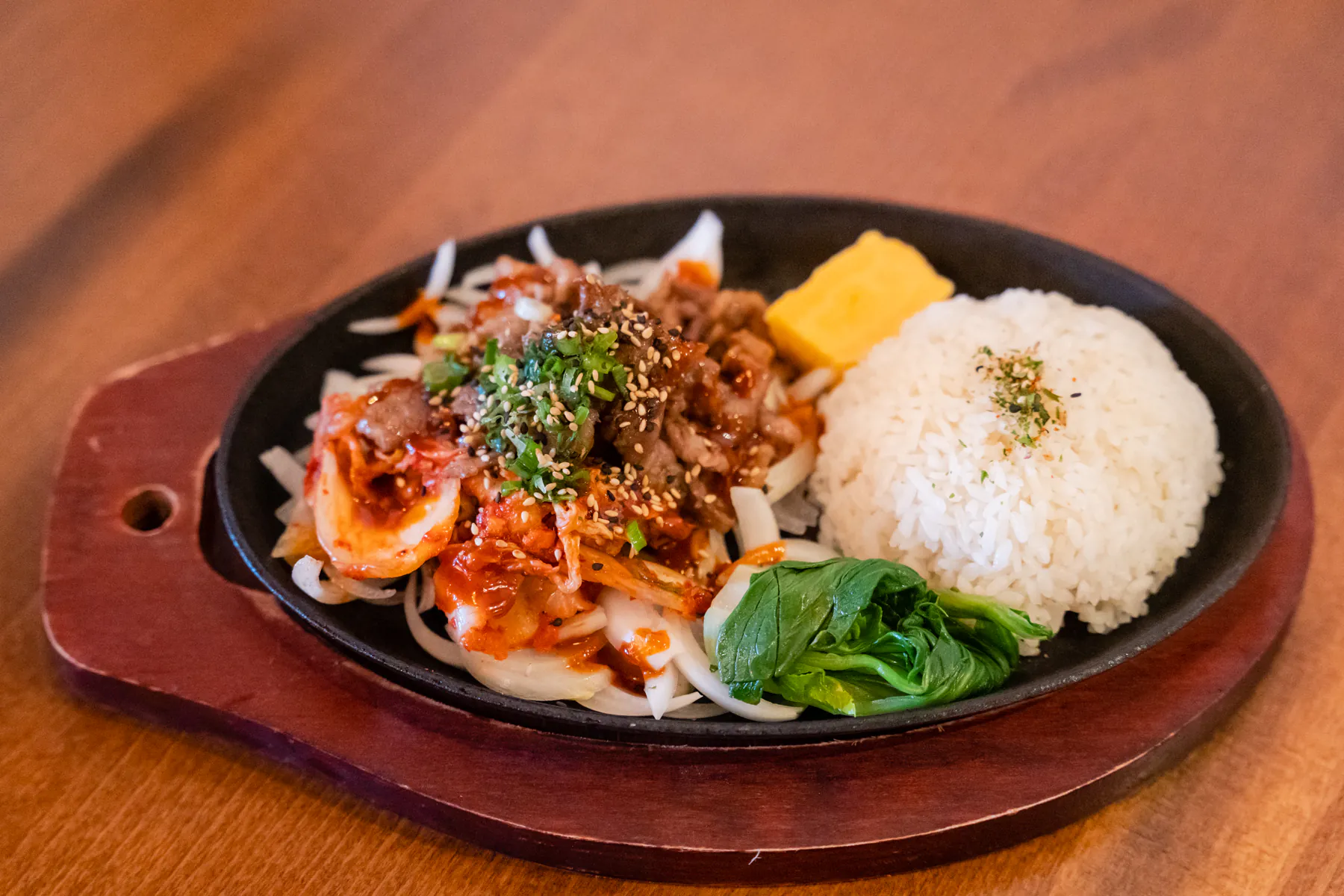 Spicy pork hot plate with rice and kimchi at Aji Izakaya Cypress, a Japanese Restaurant in Cypress